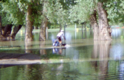 Frank riding his bike through the flood.