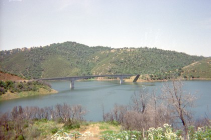 Distant highway bridge over body of water.
