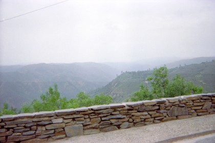Looking over rock wall at mist-shrouded valley.
