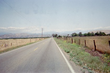 Looking down the road, fence right.