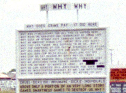 Closeup of one sign, 'Why Why Why...'