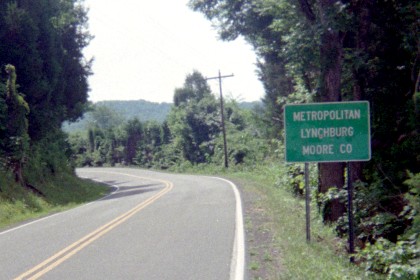 Deserted country road with sign 'Metropolitan Lynchburg'