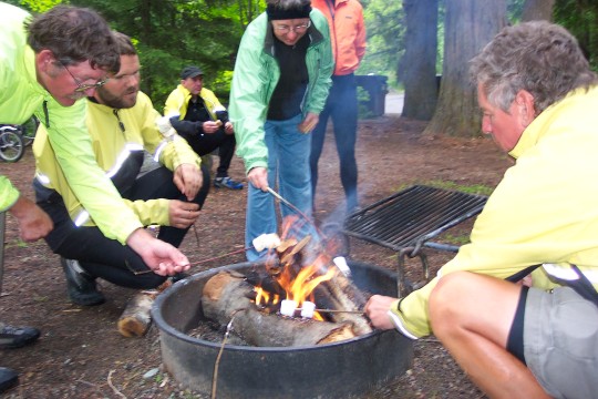 Campers roasting marshmallows over a fire