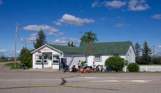 Small store with cyclists in front