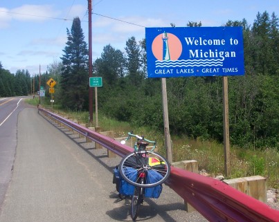 My bike with wheel strapped to the rack and Michigan sign