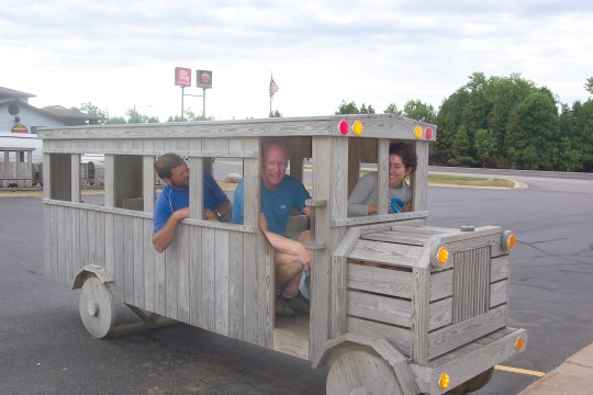 Maddy at the wheel of a wooden bus