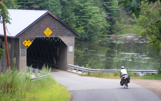 Don riding into a covered bridge