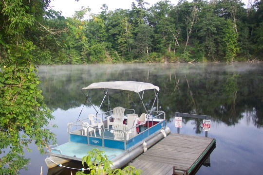 Boat at dock with mist over the water