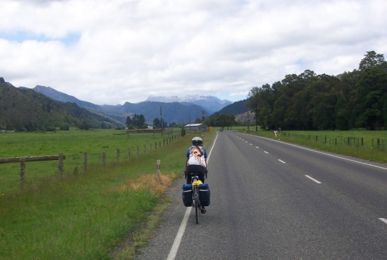 Sue riding with mountains in the background