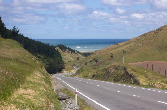 Road descending through the hills to the sea