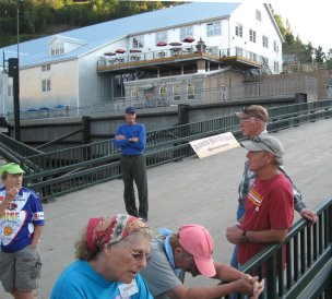 People on a bridge with converted factory in background