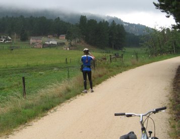 Rear view of Sue taking photo of field