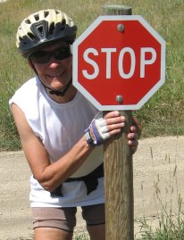 Sue mugging next to small STOP sign