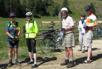 Riders facing camera with fence and gate in background