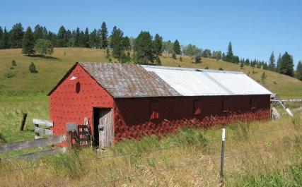 Barn with circular lids covering roof and sides