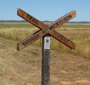 X-shaped sign like RR crossing 'Trail Head Goerge S. Mickelson'