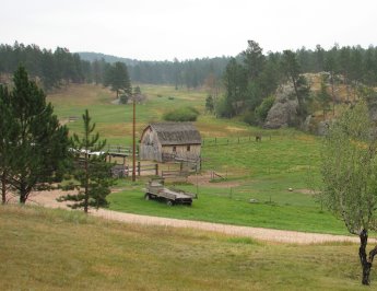 Looking down at green fields with small barn