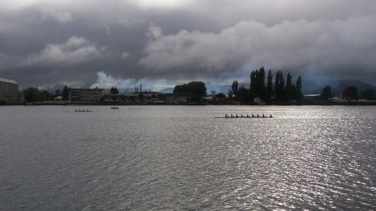 Sculling shells on the river at sunset