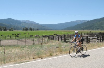 Sue riding through the valley with the mountains in the background