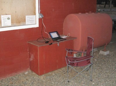 Laptop computer and chair next to the bath house