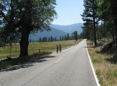 Two cyclists on the road in the valley