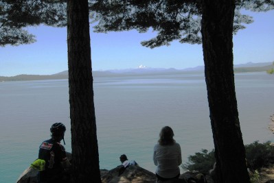 Silhouettes of cyclists against the lake