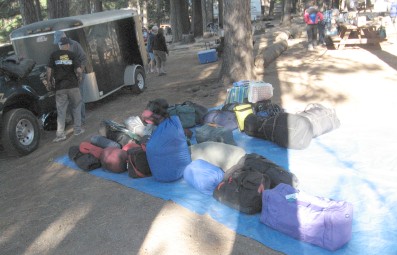 The luggage on a tarp, ready to load into the trailer