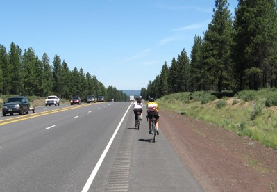 Several cyclists riding on the freewayshoulder