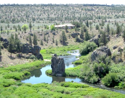 Looking down in valley with stream and giant rock