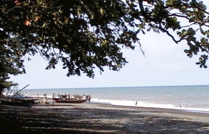People preparing to launch boat on beach