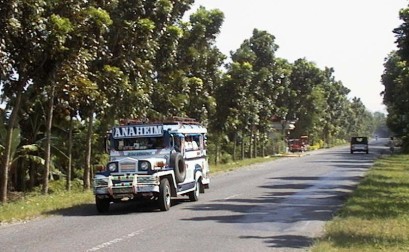 Brightly-colored jeepney on country road