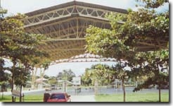 Steel-girdered roof over large concrete pad