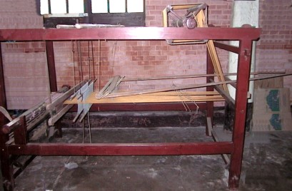 Loom with brick wall in background