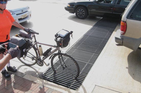 Demonstrating a bike wheel eaten by a grate