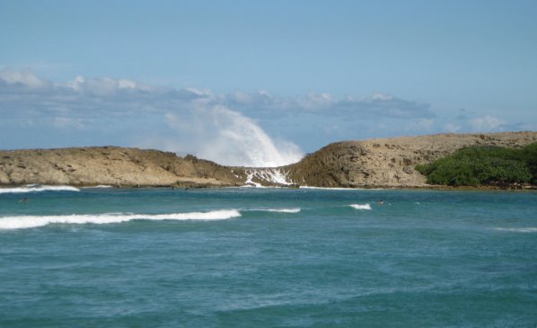 Bay with blowhole behind rocks at other side