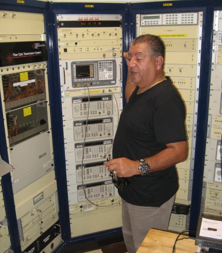 Racks of equipment with Sr. Vasquez in front